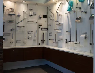 Präsentationswand der Stübler GmbH mit einer Vielzahl an modernen Badaccessoires wie Handtuchhaltern, Seifenspendern und Toilettenpapierhaltern in einem hell ausgeleuchteten Showroom.